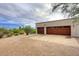 Two-car garage with wood doors and a brick paved driveway at 9446 E Romping Rd, Carefree, AZ 85377