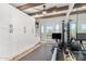 Home gym with rowing machine, storage, and wood beam ceiling at 9446 E Romping Rd, Carefree, AZ 85377
