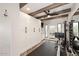 Home gym with rowing machine, storage, and wood beam ceiling at 9446 E Romping Rd, Carefree, AZ 85377