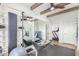 Home gym with rowing machine, storage, and wood beam ceiling at 9446 E Romping Rd, Carefree, AZ 85377