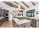 Modern kitchen with granite island, stainless steel appliances, and wood beams at 9446 E Romping Rd, Carefree, AZ 85377