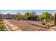 Landscaped backyard features gravel, stone pathways, and desert landscaping at 9446 E Romping Rd, Carefree, AZ 85377