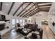 Open living area with a view of kitchen, fireplace, and hardwood floors at 9446 E Romping Rd, Carefree, AZ 85377