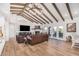 Open living room with vaulted ceilings, a fireplace, and hardwood floors at 9446 E Romping Rd, Carefree, AZ 85377