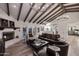 Open concept living room with fireplace, hardwood floors, and access to patio at 9446 E Romping Rd, Carefree, AZ 85377