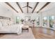 Spacious main bedroom with wood beam ceiling and access to the patio at 9446 E Romping Rd, Carefree, AZ 85377