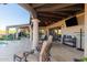 Covered patio with comfortable seating and a view of the pool at 9446 E Romping Rd, Carefree, AZ 85377