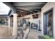 Covered patio features comfortable seating and outdoor TV at 9446 E Romping Rd, Carefree, AZ 85377