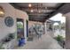 Covered patio with seating area, stone flooring, and a chandelier at 9446 E Romping Rd, Carefree, AZ 85377