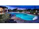 Stunning nighttime view of a kidney-shaped pool at 9446 E Romping Rd, Carefree, AZ 85377