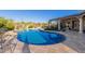 Stunning kidney-shaped pool surrounded by a spacious patio at 9446 E Romping Rd, Carefree, AZ 85377