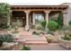 Stunning entry to a Southwestern-style home with a covered porch and brick steps at 10125 E Sundance Trl, Scottsdale, AZ 85262