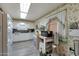 Kitchen with white cabinets, laminate floors, and floral wallpaper at 10340 W Mountain View Rd, Sun City, AZ 85351