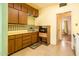 Vintage kitchen with wood cabinets, yellow countertops, and a built-in microwave at 121 W Glenrosa Ave, Phoenix, AZ 85013