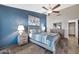 Charming bedroom with blue accent wall and wood furniture at 1226 E San Remo Ave, Gilbert, AZ 85234