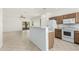 Kitchen with wood cabinets, white appliances, and a breakfast bar at 1440 E Bautista Rd, Gilbert, AZ 85297