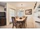 Charming dining area with a wood table, four chairs, and a chandelier at 145 N 74Th St # 108, Mesa, AZ 85207