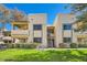 Tan two-story condo building with grassy yard and stairs at 145 N 74Th St # 108, Mesa, AZ 85207