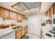 Clean kitchen featuring wood cabinets and white appliances at 145 N 74Th St # 108, Mesa, AZ 85207