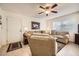 Living room featuring two sofas, a coffee table and a ceiling fan at 145 N 74Th St # 108, Mesa, AZ 85207