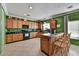 Kitchen with wood cabinets, an island, and black countertops at 2122 N 94Th Ln, Phoenix, AZ 85037