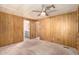 Cozy bedroom with wood paneling and access to bathroom at 245 S 56Th St # 75, Mesa, AZ 85206