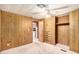 Charming bedroom with wood paneling, closet, and ceiling fan at 245 S 56Th St # 75, Mesa, AZ 85206
