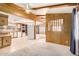 Open living space with wood paneling and kitchen view at 245 S 56Th St # 75, Mesa, AZ 85206