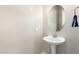 Clean bathroom with pedestal sink and oval mirror at 2456 E Lindrick Dr, Gilbert, AZ 85298