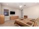 Relaxing bedroom with ceiling fan, dresser, and a large TV at 2456 E Lindrick Dr, Gilbert, AZ 85298