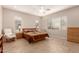 Comfortable bedroom with ceiling fan, dresser, and a rocking chair at 2456 E Lindrick Dr, Gilbert, AZ 85298