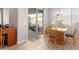 Bright dining area with wooden table and chairs, providing access to the backyard at 2456 E Lindrick Dr, Gilbert, AZ 85298