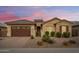 Single-story home with a two-car garage and desert landscaping at 2456 E Lindrick Dr, Gilbert, AZ 85298
