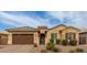 Two-story house with brown garage door and stone accents at 2456 E Lindrick Dr, Gilbert, AZ 85298
