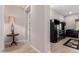 Elegant hallway with dark wood cabinet and a side table with lamp at 2456 E Lindrick Dr, Gilbert, AZ 85298
