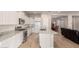 Open kitchen boasts white cabinets, granite countertops, and stainless steel appliances at 2456 E Lindrick Dr, Gilbert, AZ 85298
