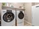 Laundry room with washer, dryer and storage at 2456 E Lindrick Dr, Gilbert, AZ 85298