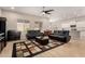 Living room with black reclining sofas and a large TV at 2456 E Lindrick Dr, Gilbert, AZ 85298