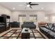 Living room with two black reclining sofas and an area rug at 2456 E Lindrick Dr, Gilbert, AZ 85298