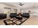 Spacious living room with two black leather reclining sofas and a coffee table at 2456 E Lindrick Dr, Gilbert, AZ 85298