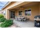 Covered patio with dining table, grill, and ceiling fan at 2456 E Lindrick Dr, Gilbert, AZ 85298