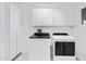 Bright laundry room with white cabinets and Whirlpool appliances at 2456 E Vista Dr, Phoenix, AZ 85032