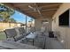 Covered patio with seating area, ceiling fan, and TV at 2456 E Vista Dr, Phoenix, AZ 85032