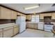 Kitchen with light wood cabinets, white appliances, and a window at 28345 N 84Th St, Scottsdale, AZ 85266