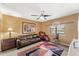 Comfortable bedroom with leather sofa, ceiling fan, and plenty of natural light at 29806 N 43Rd Pl, Cave Creek, AZ 85331