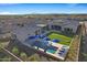 Aerial view of the home's backyard featuring a pool, putting green, and patio area at 30807 N 117Th Dr, Peoria, AZ 85383