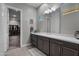 Elegant bathroom with a single vanity, modern fixtures, and a walk-in closet access at 30807 N 117Th Dr, Peoria, AZ 85383