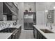 Modern kitchen with stainless steel appliances, a large island, and white quartz countertops at 30807 N 117Th Dr, Peoria, AZ 85383