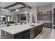 Open concept kitchen and living area with wooden beams, large island, and white countertops at 30807 N 117Th Dr, Peoria, AZ 85383