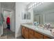 Bathroom with double vanity and large mirror at 3339 E Tonopah Dr, Phoenix, AZ 85050
